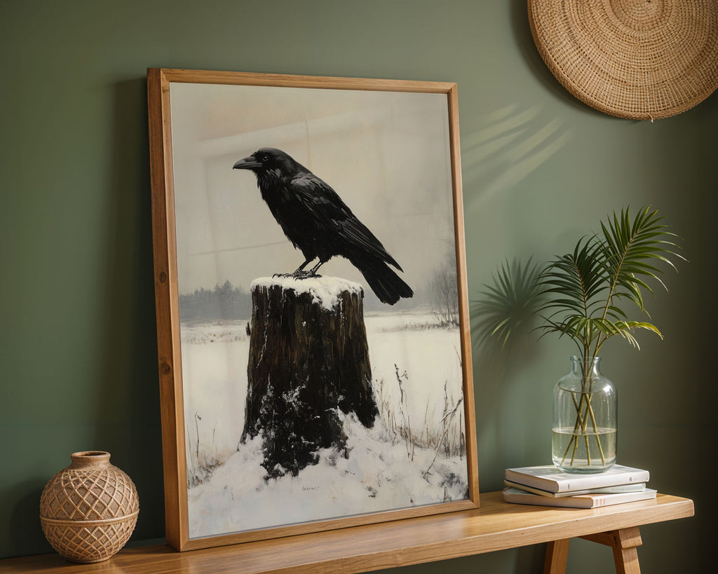 Framed crow poster displayed in a living room above a fireplace mantel with natural decor